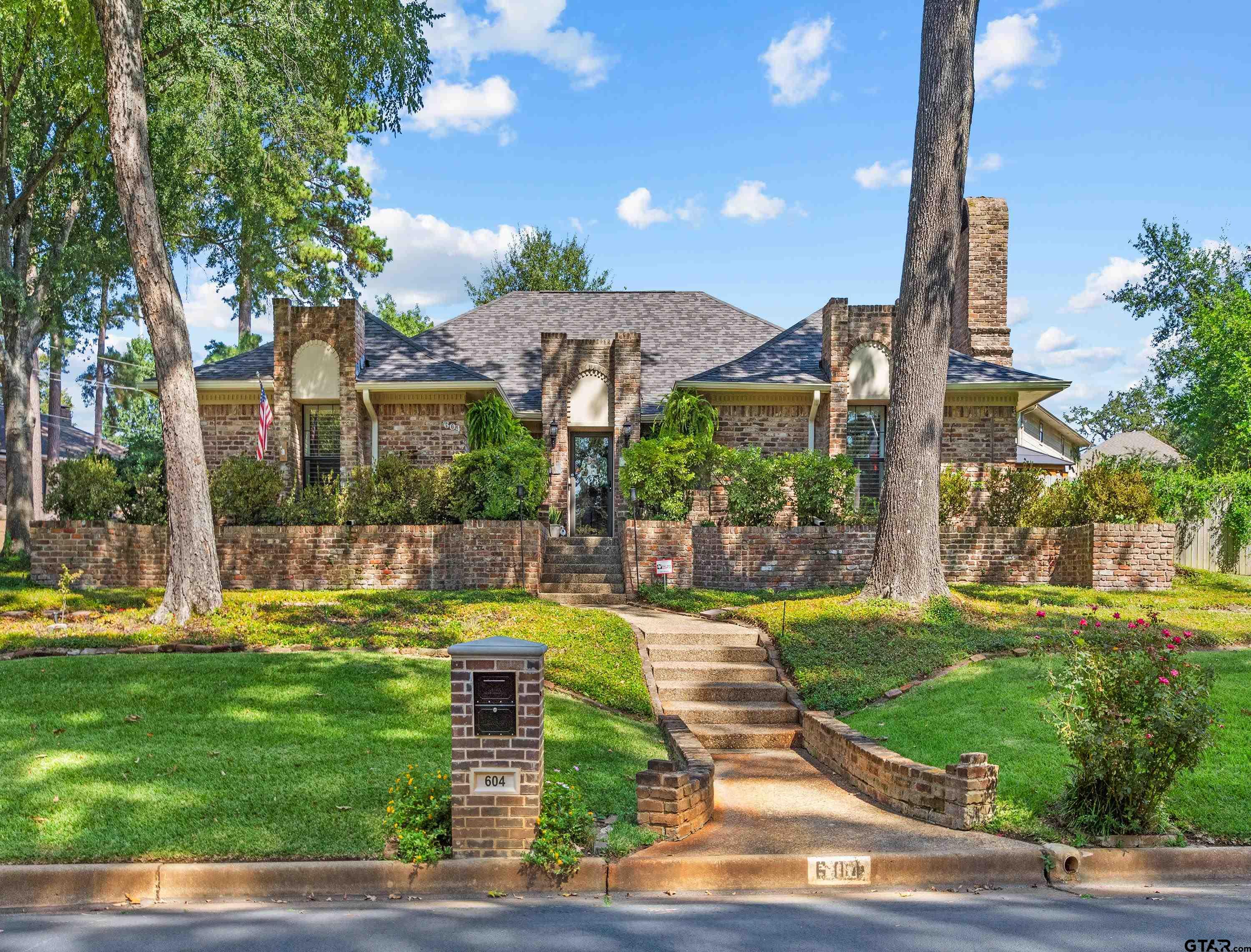 a view of a house with swimming pool and a yard