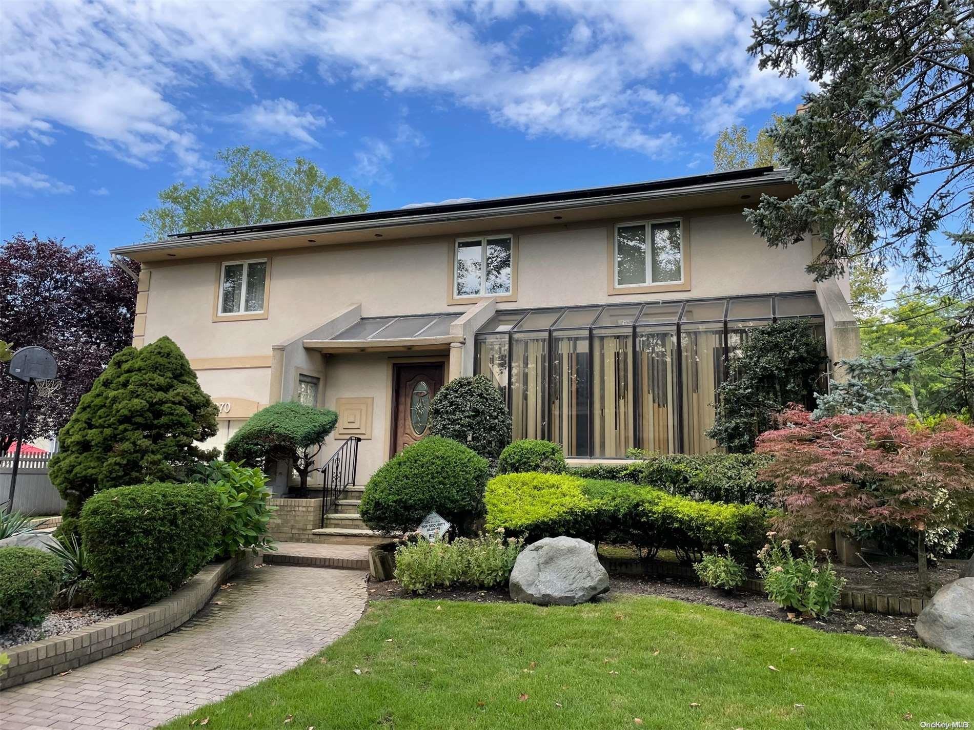 a front view of a house with garden