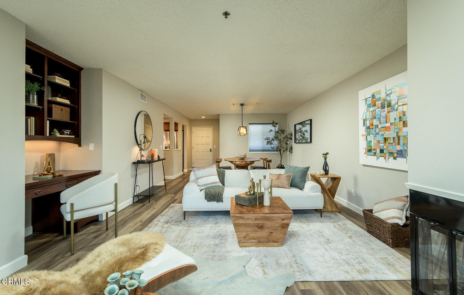 a living room with furniture and painting on the wall