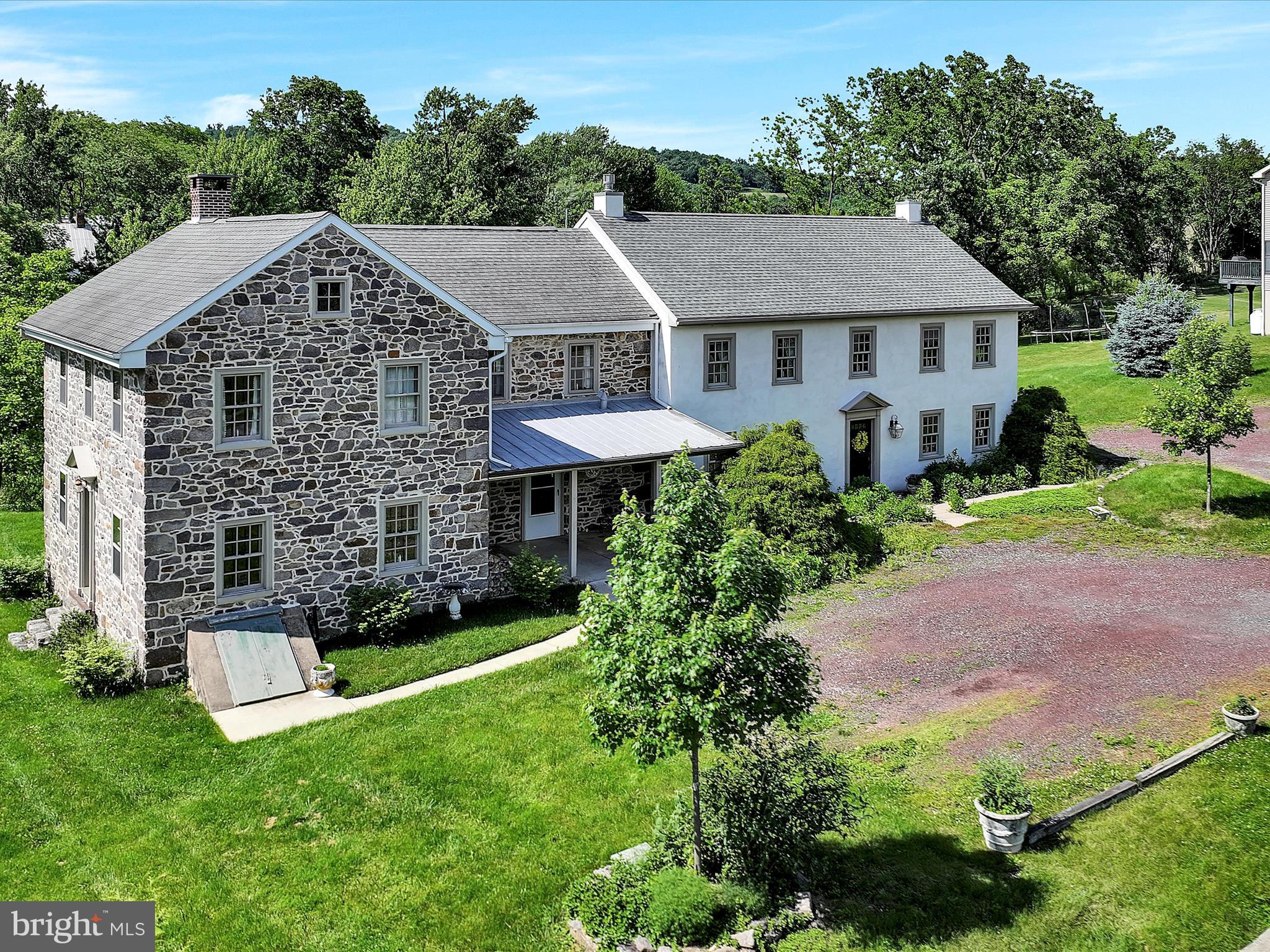 a aerial view of a house next to a yard and trees