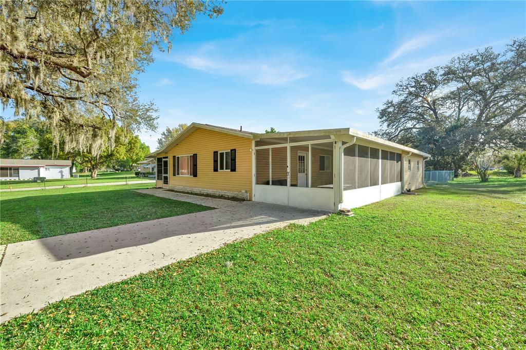 a view of a house with a backyard