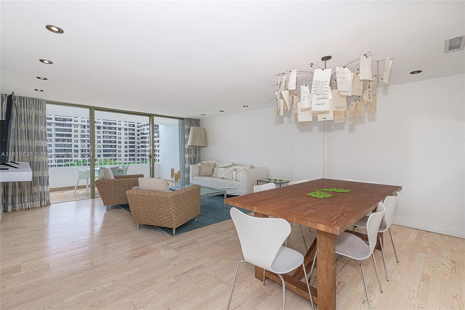 a view of a dining room with furniture wooden floor and chandelier