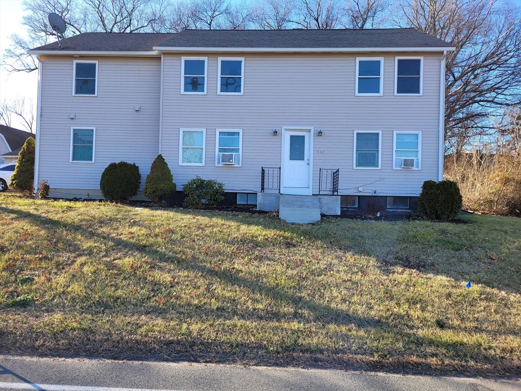 a view of a house with a yard