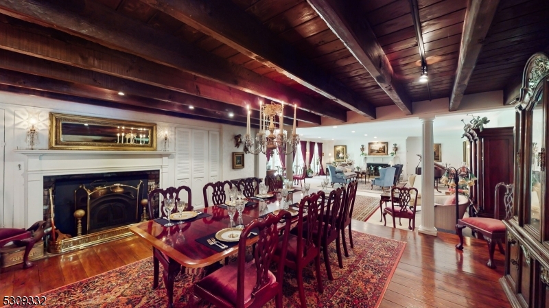 a view of a dining room with furniture wooden floor and a fireplace