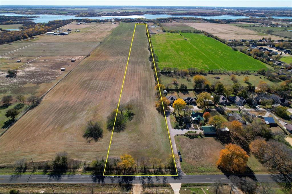 an aerial view of a house with a yard and lake view