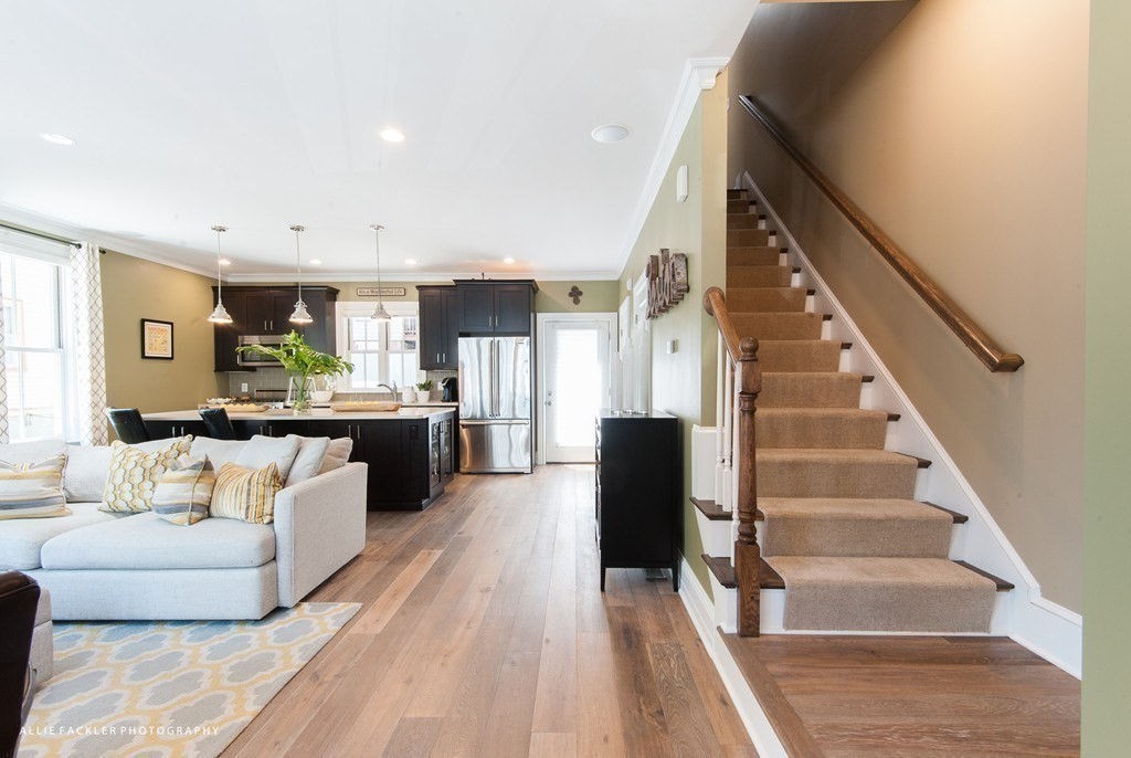 a living room with furniture and kitchen view