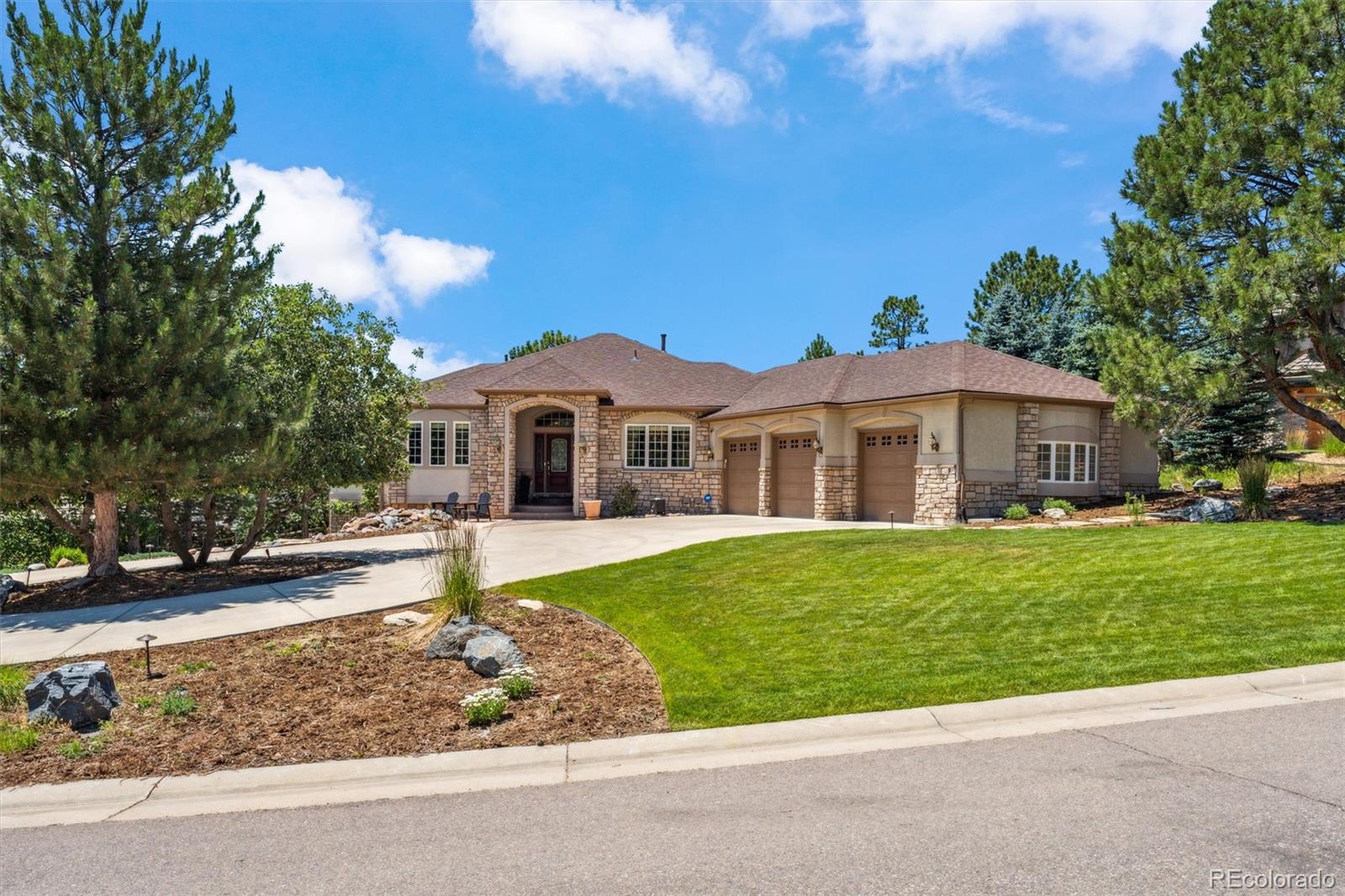 a front view of a house with a garden