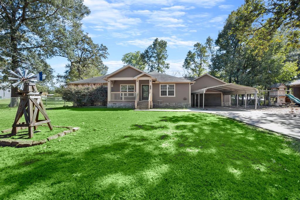 a front view of house with a garden and deck