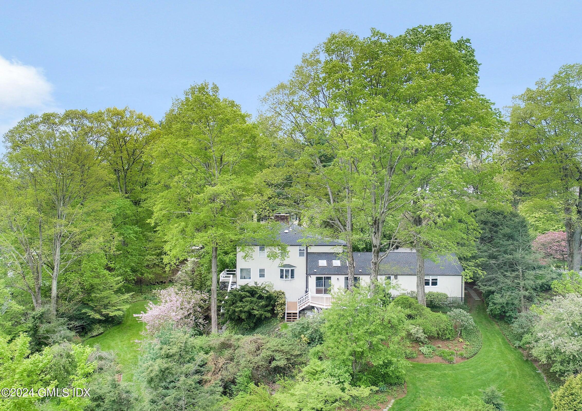 an aerial view of a house with yard and green space