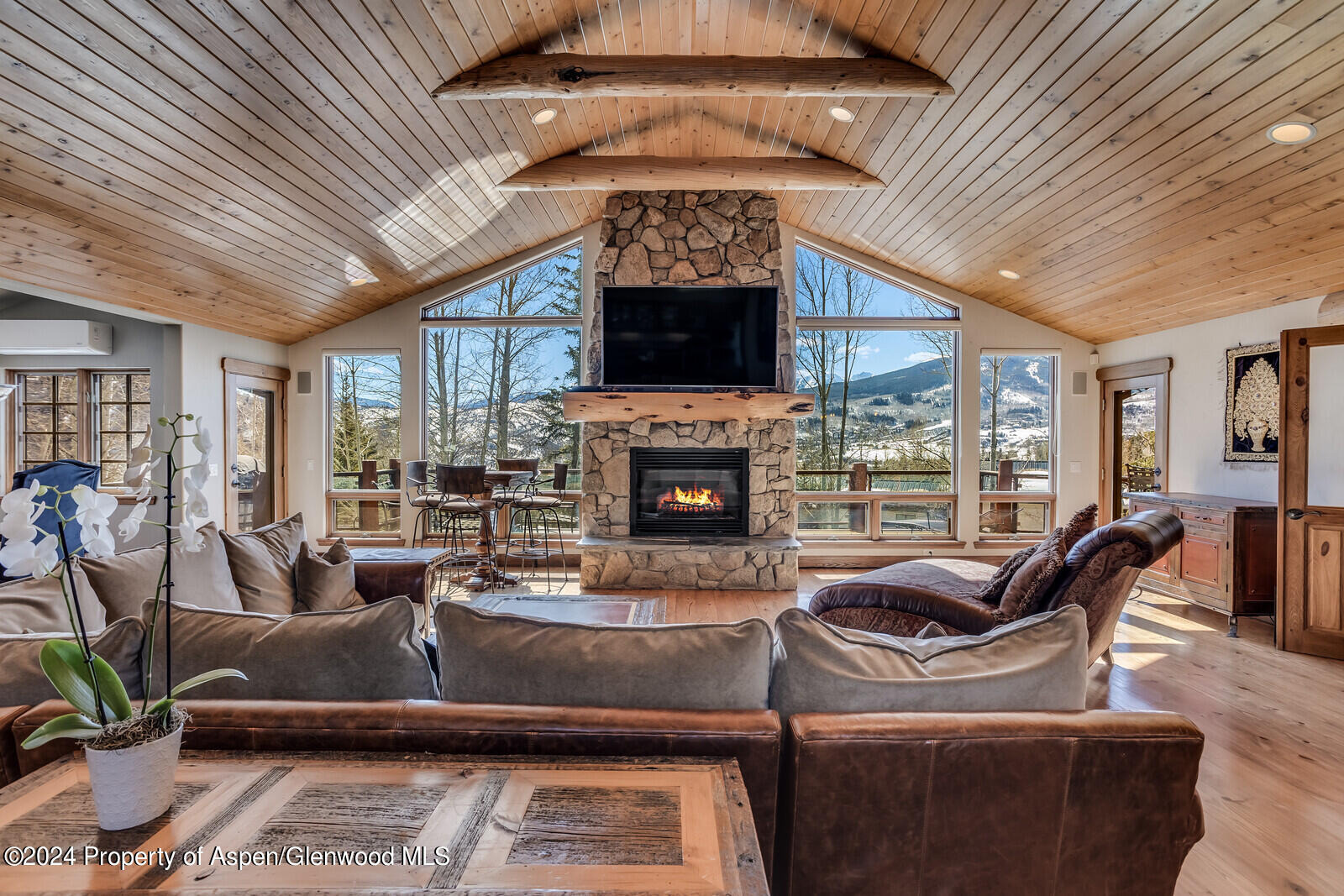 a living room with furniture large window and a fireplace