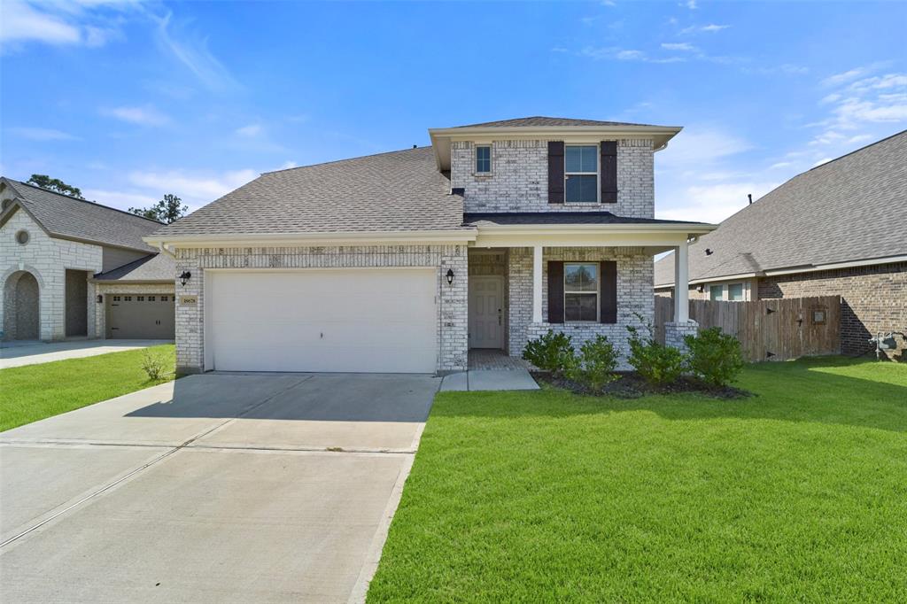 a front view of a house with a yard and garage