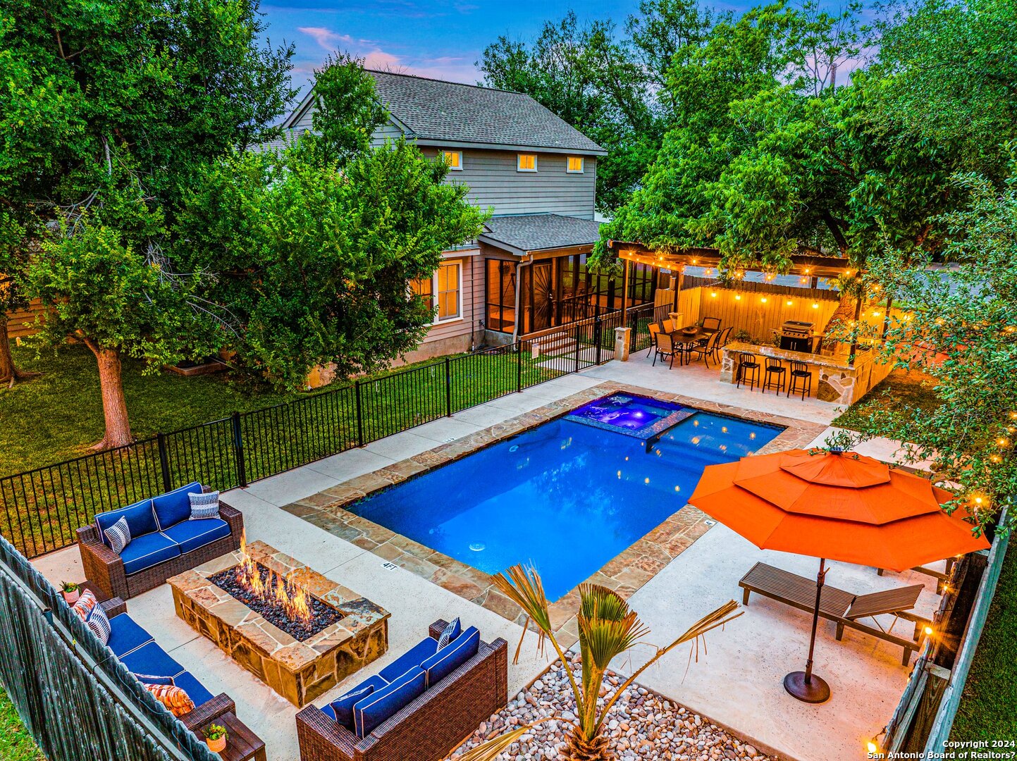 an outdoor sitting area with pool table and chairs