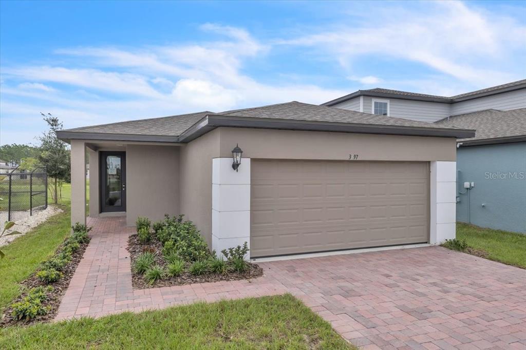 a front view of a house with a yard and garage