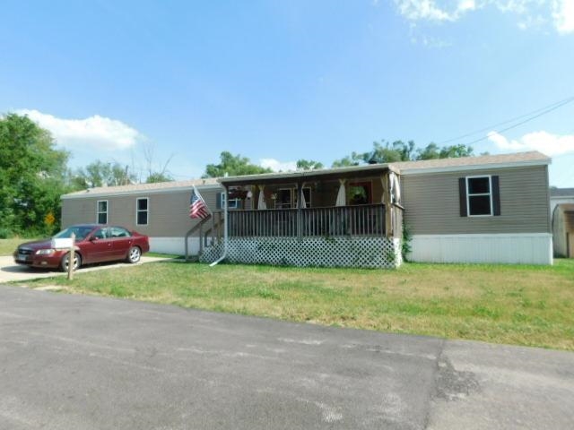 a view of a house with a patio and a yard