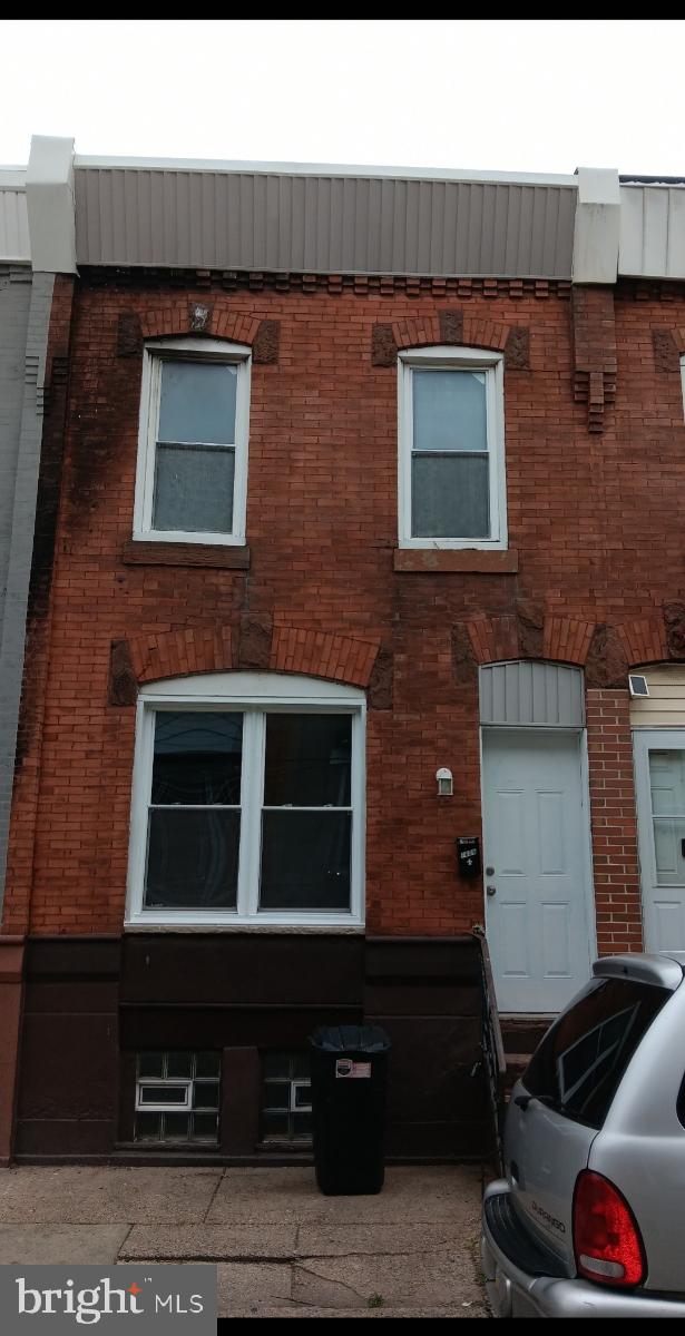 a brick building with a door and a window