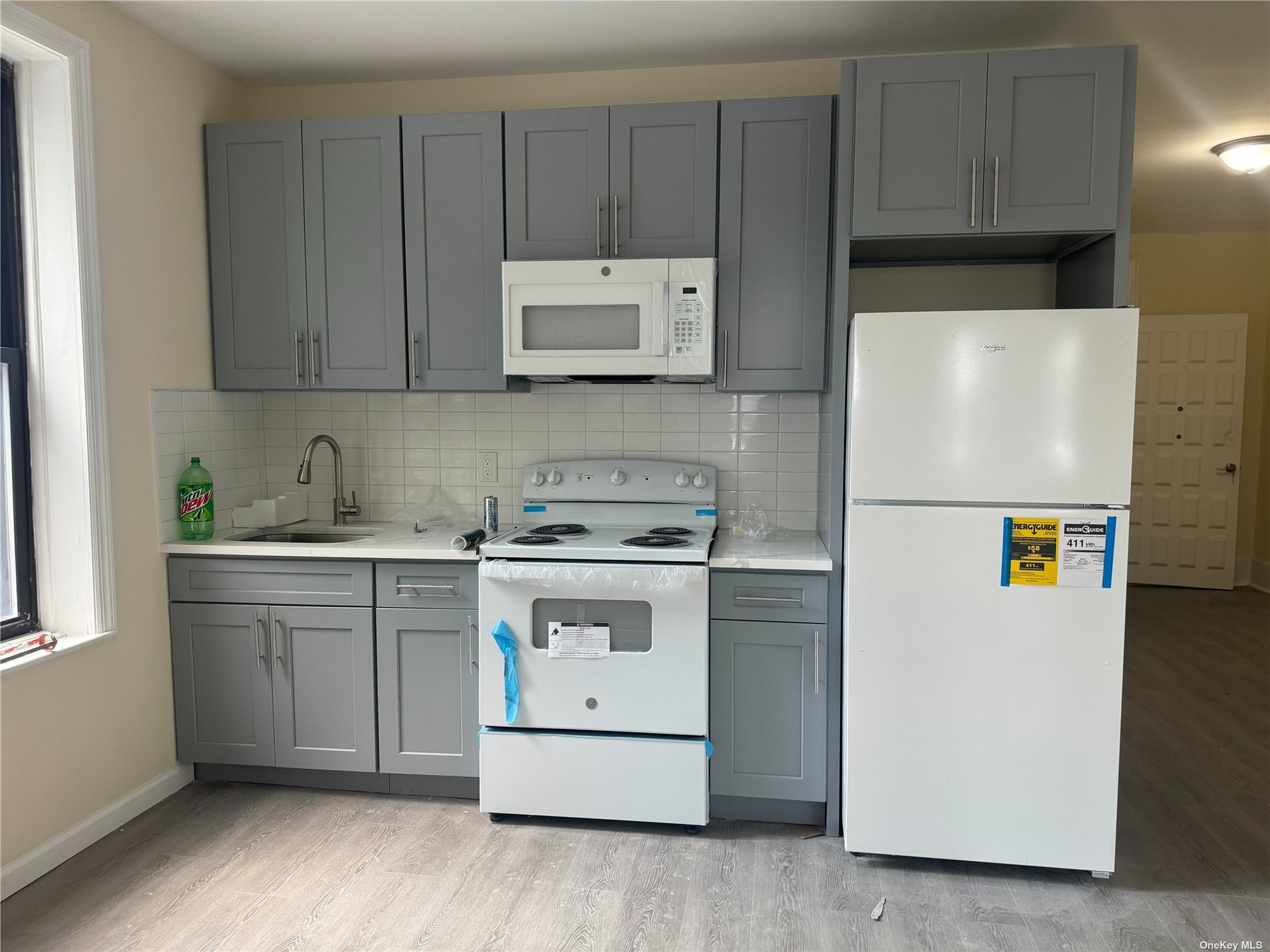 a kitchen with a refrigerator sink stove and cabinets