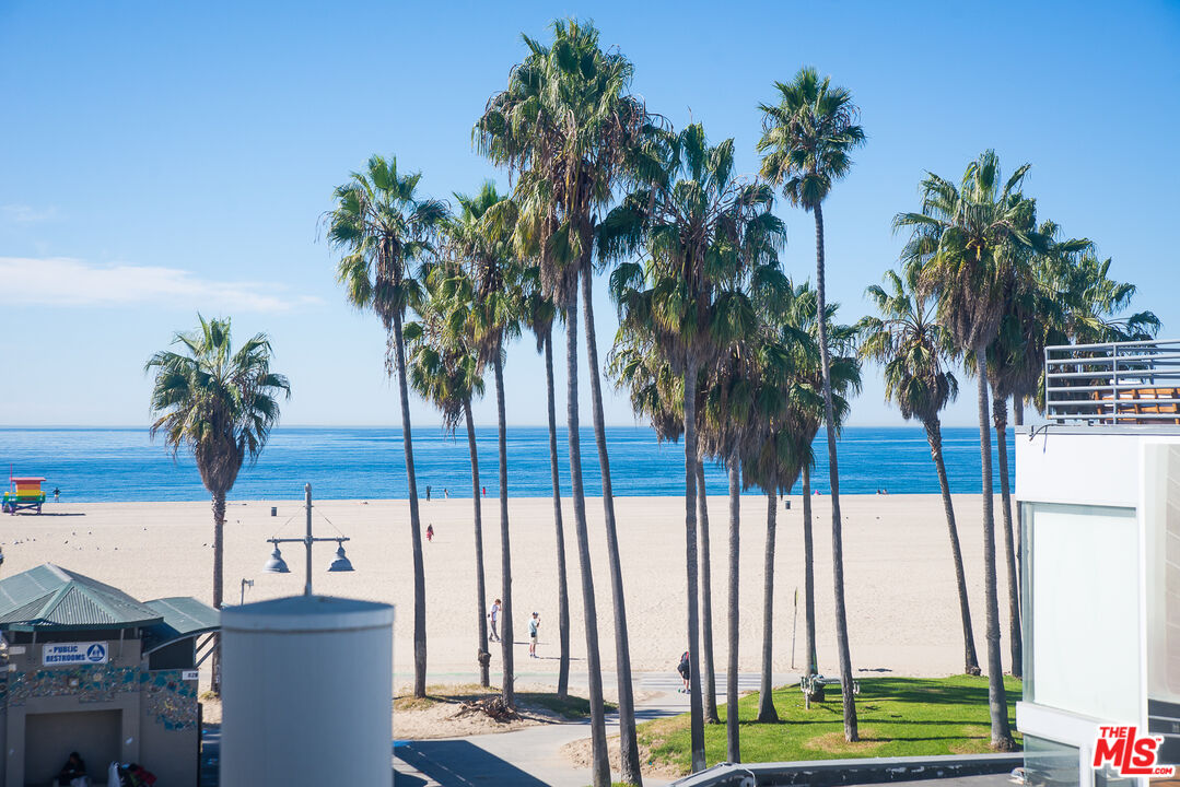 a view of multiple houses with palm trees