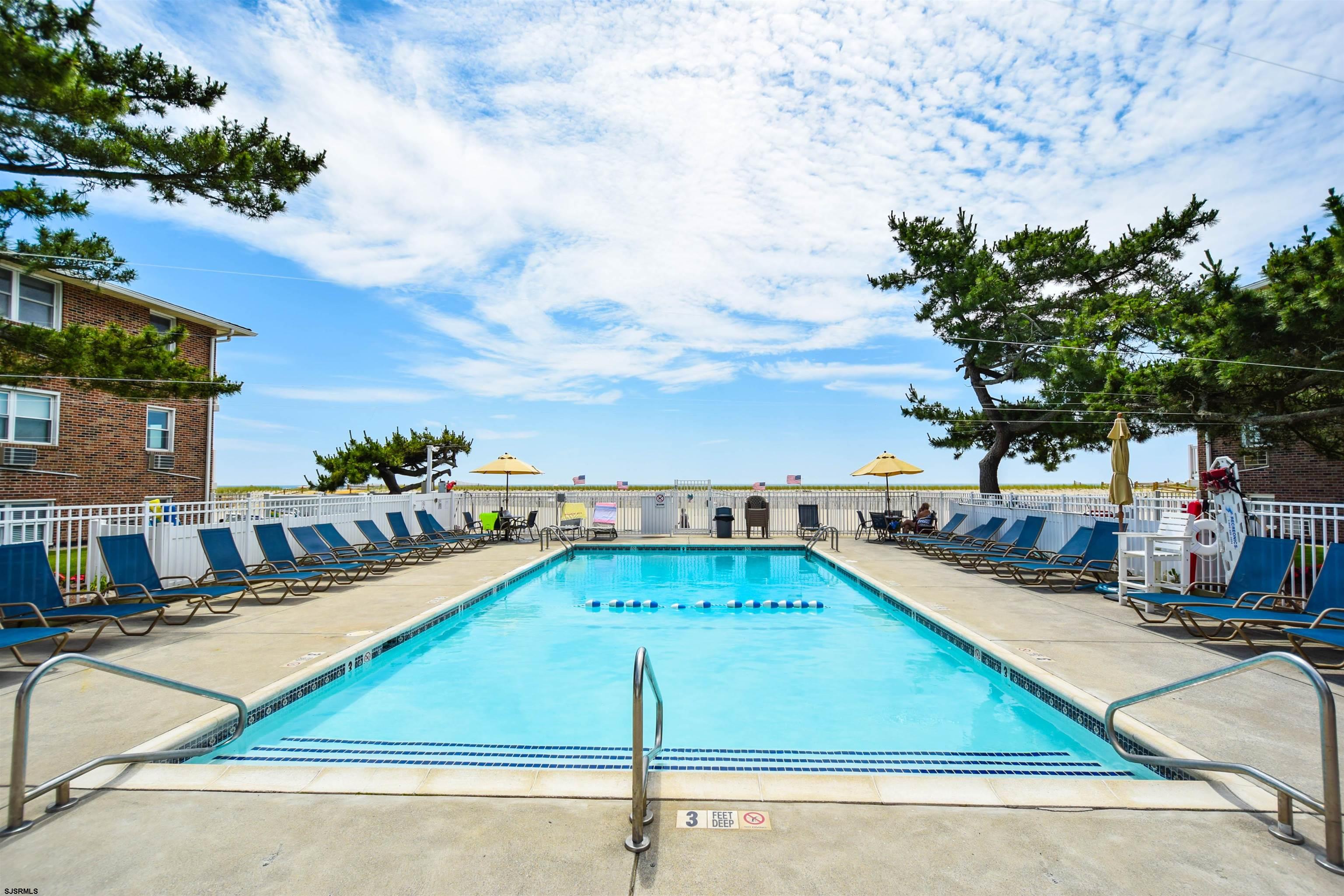 a view of a swimming pool with a lounge chairs