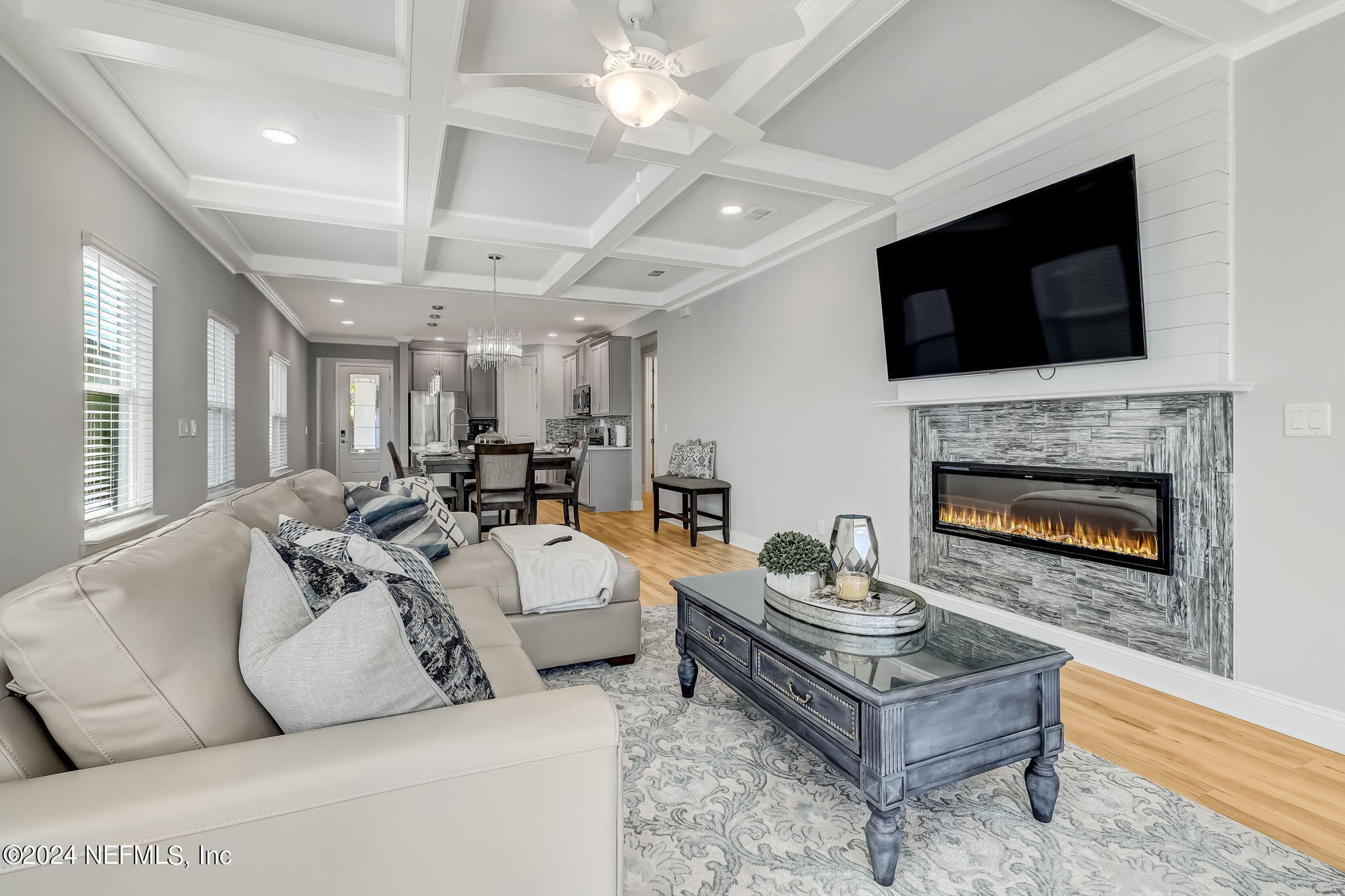 a living room with furniture a flat screen tv and a fireplace