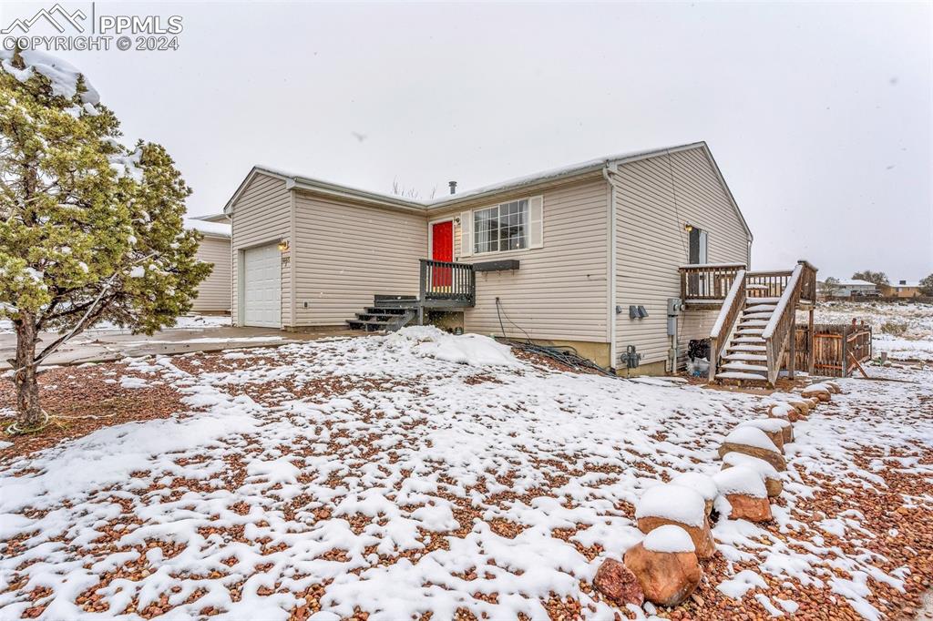 View of snow covered rear of property