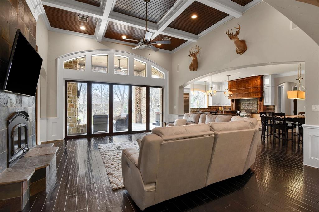 a living room with furniture a fireplace and a flat screen tv