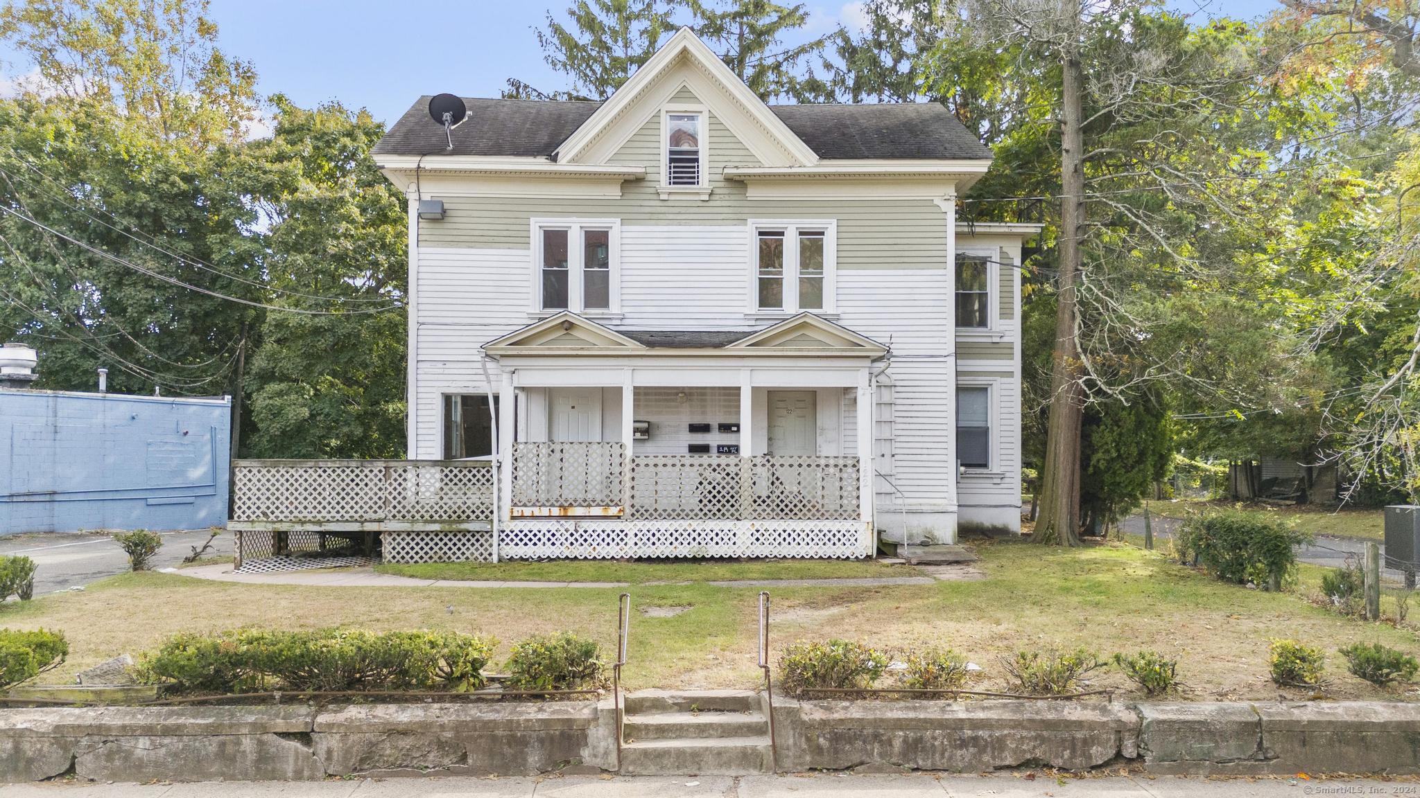 a front view of a house with swimming pool and porch