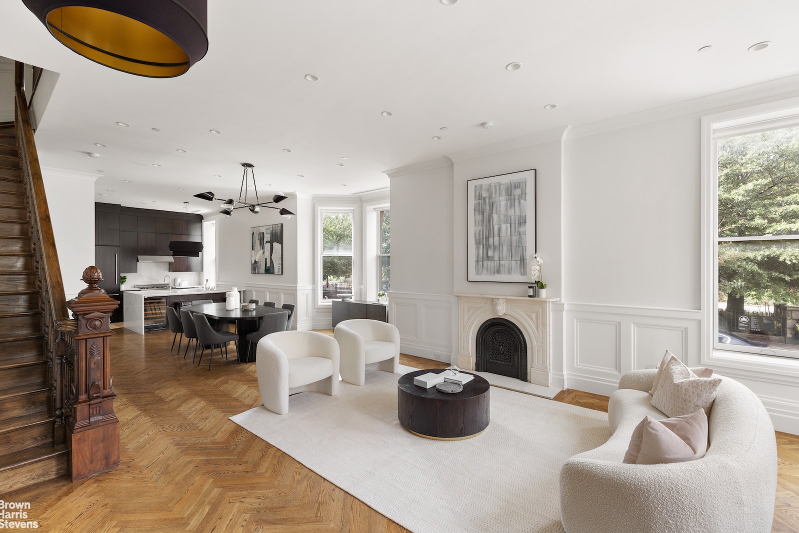 a living room with furniture a fireplace and a large window