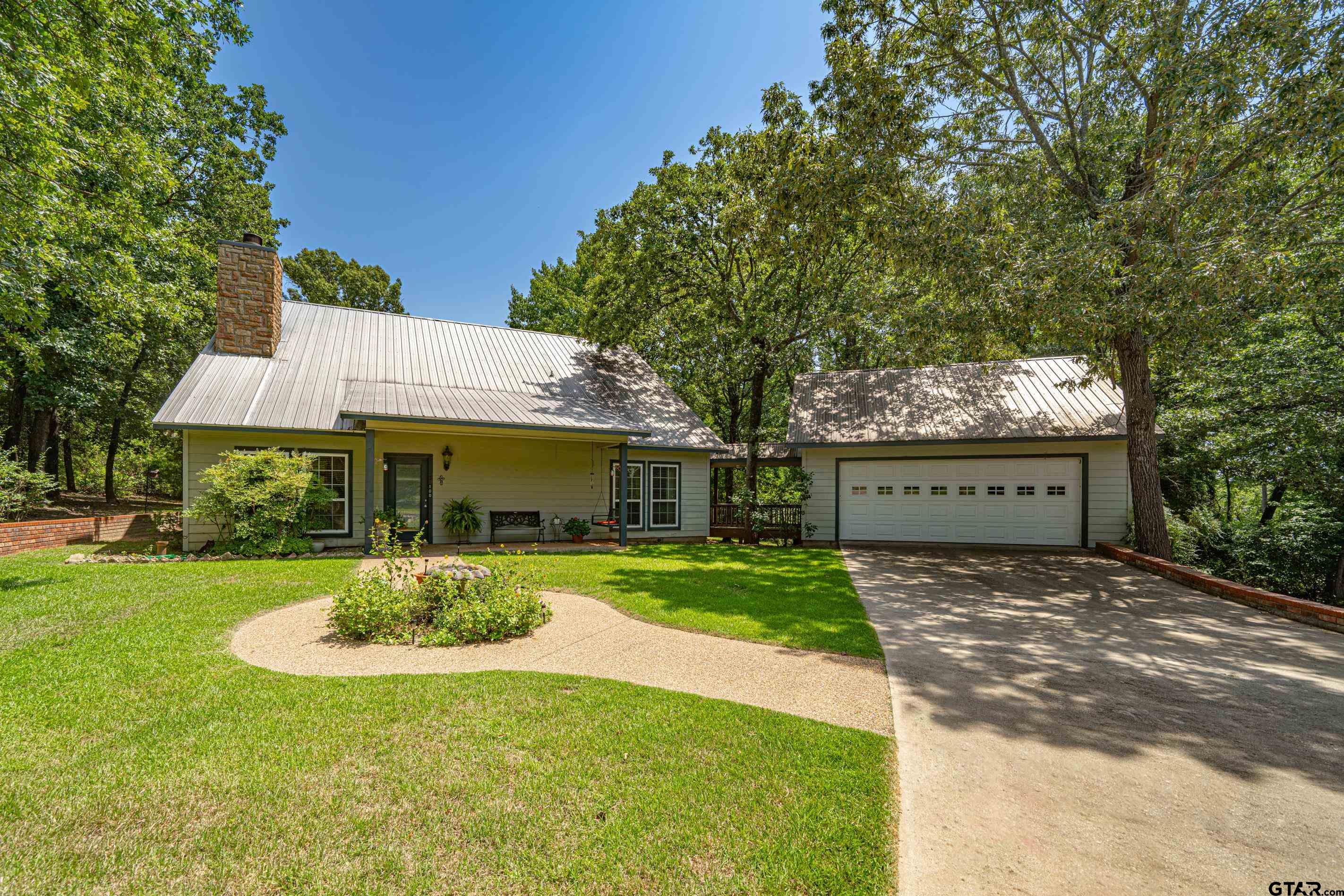 a front view of a house with a yard and porch