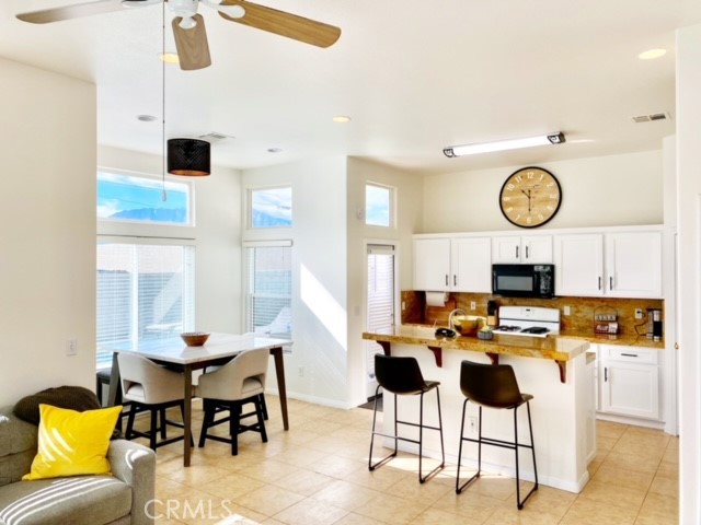 a view of a dining room with furniture and a clock