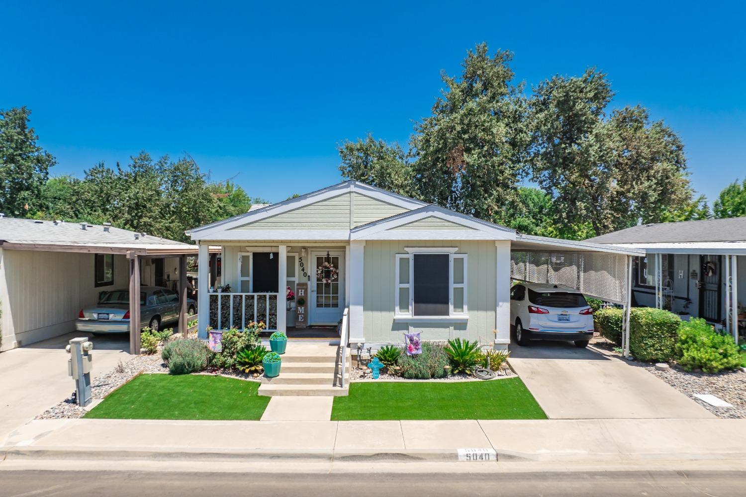 a front view of a house with a garden and patio