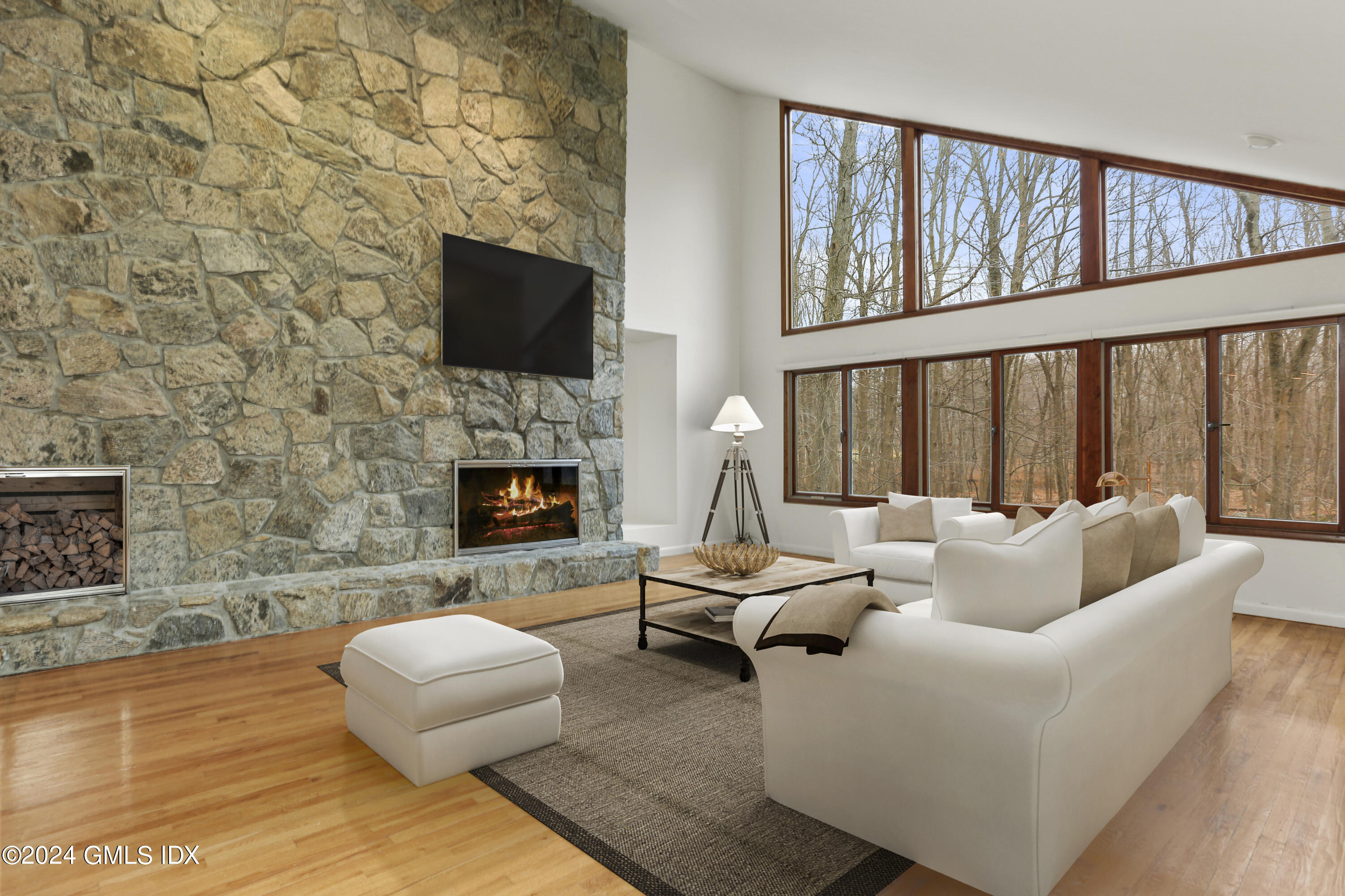 a living room with furniture fireplace and flat screen tv