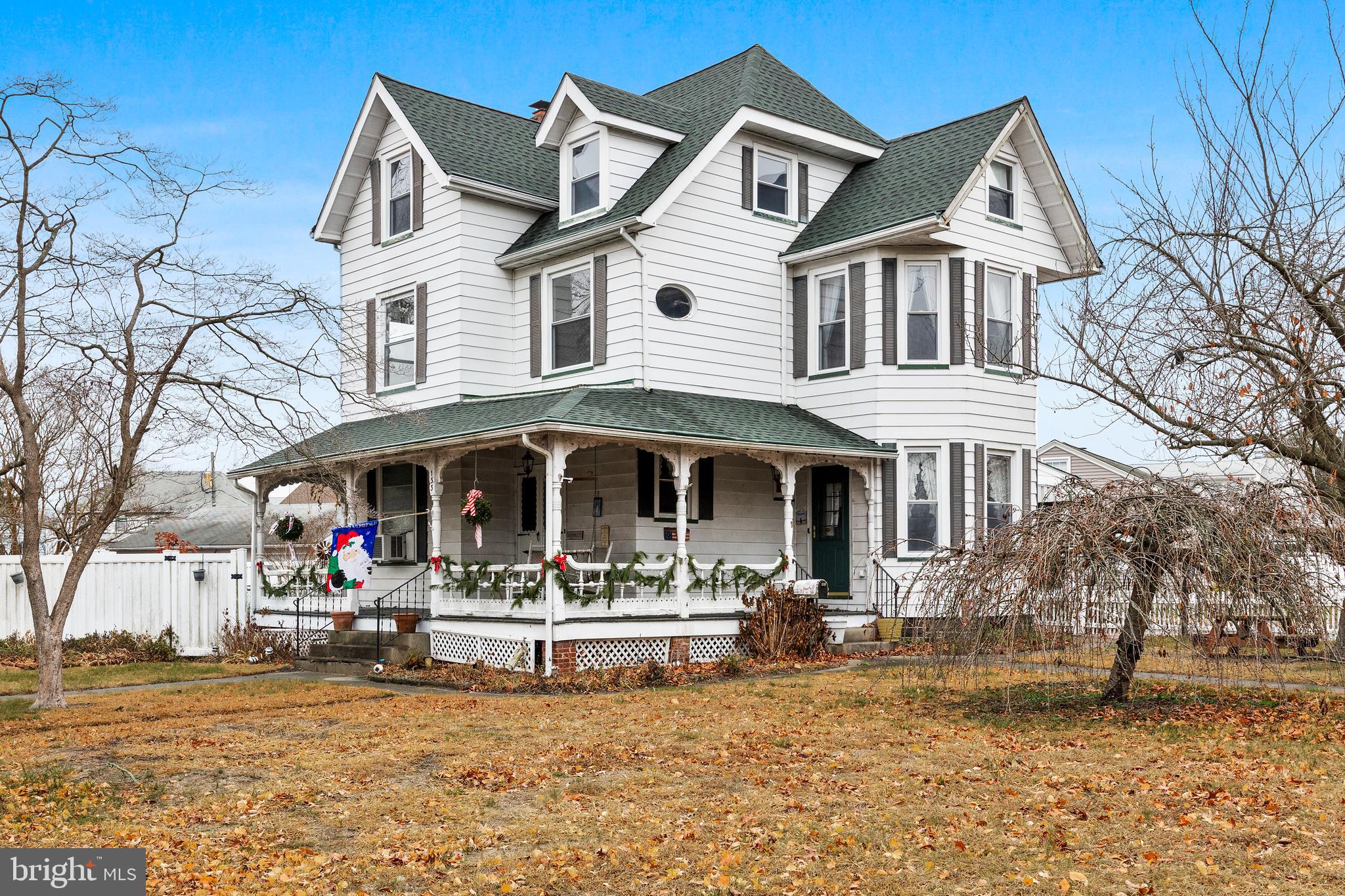 a front view of a white house with a yard