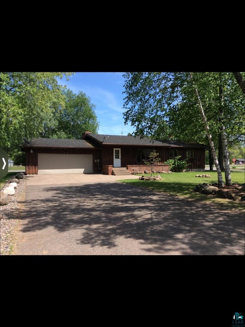 View of front of property with a garage and a front yard