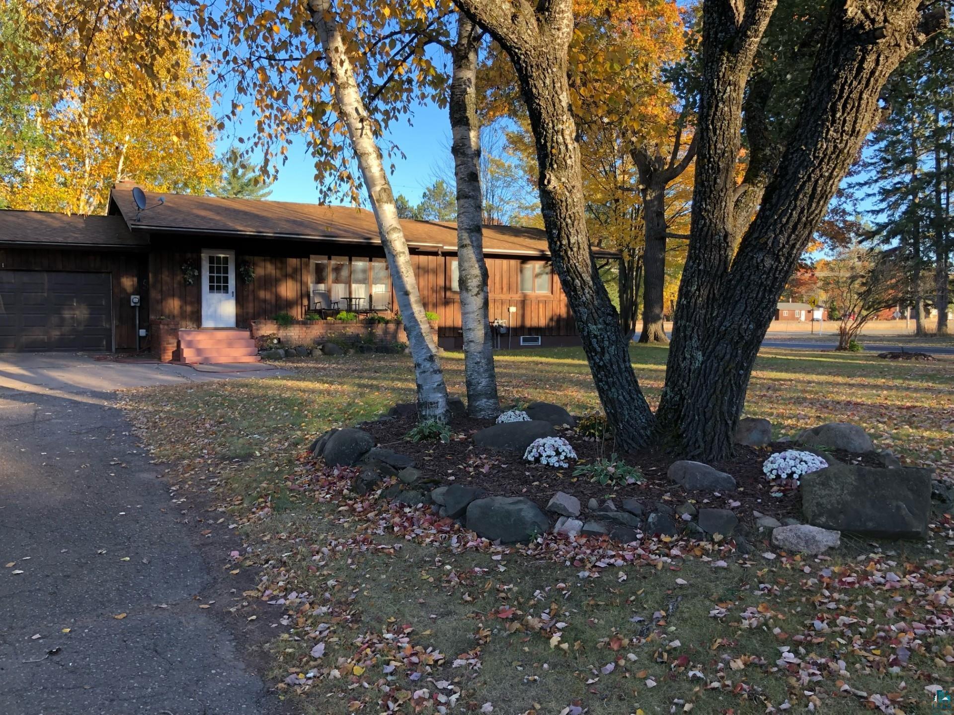 View of front of property featuring a garage and a front yard