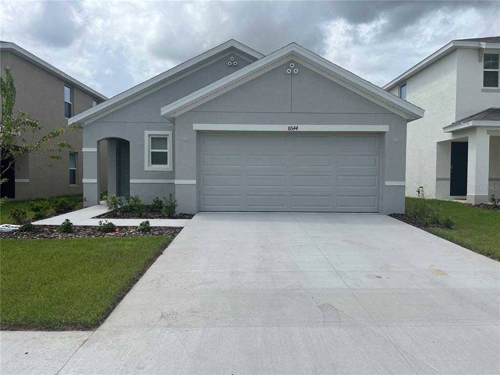 a front view of a house with a yard and garage