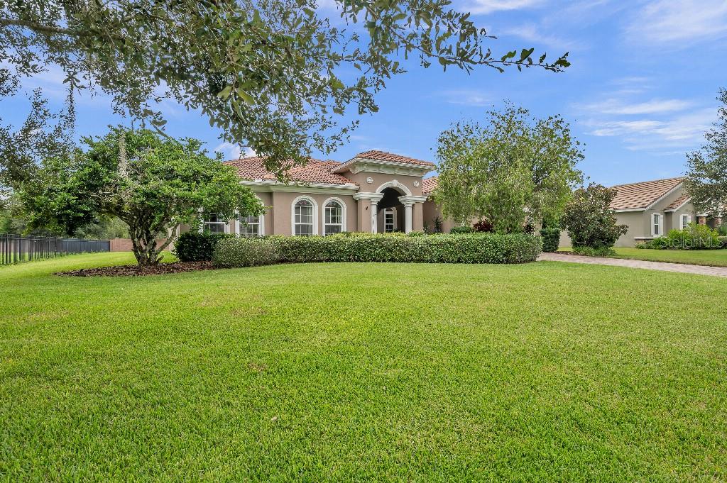 a front view of a house with a garden