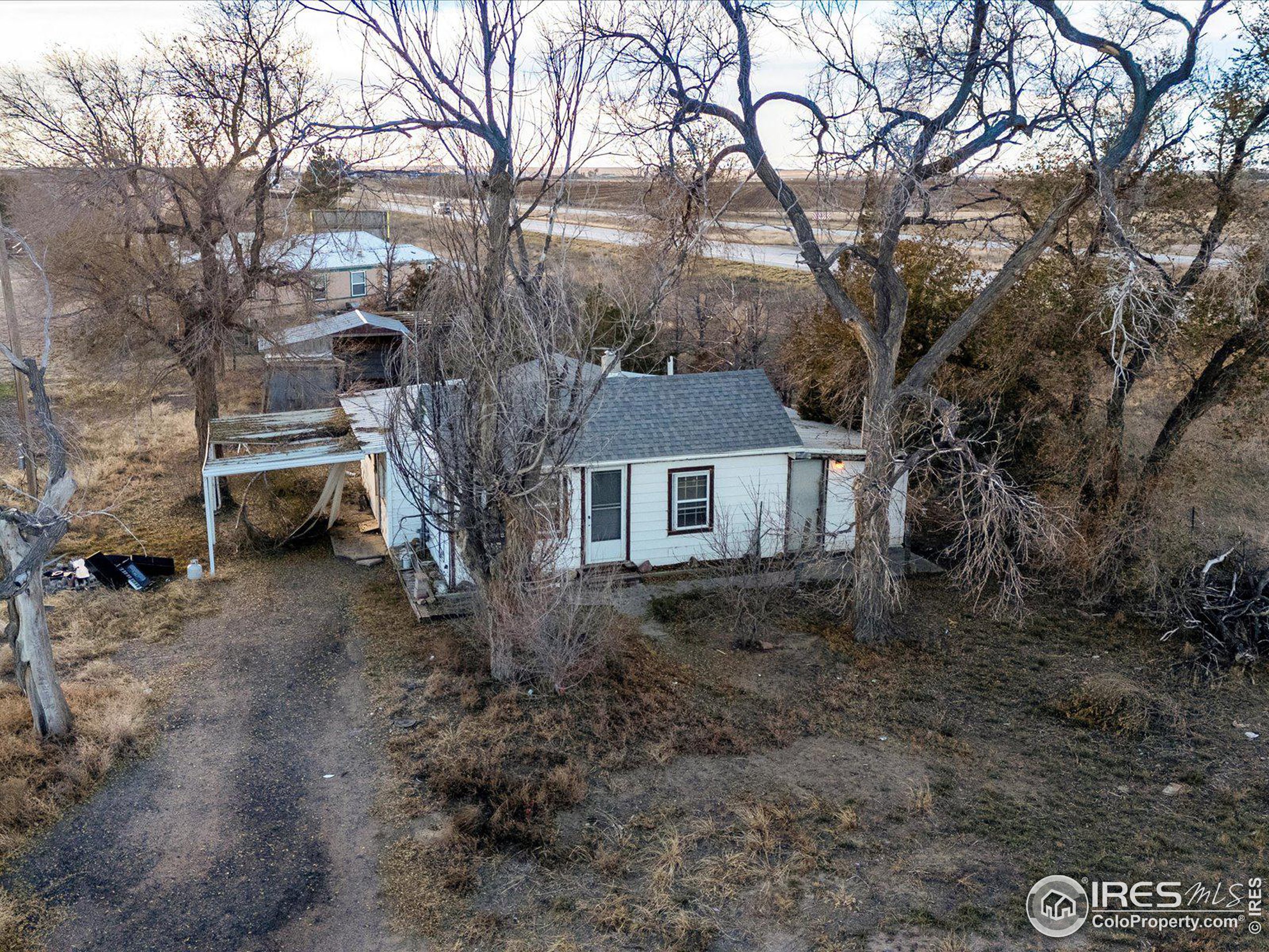 a house is sitting in middle of the forest