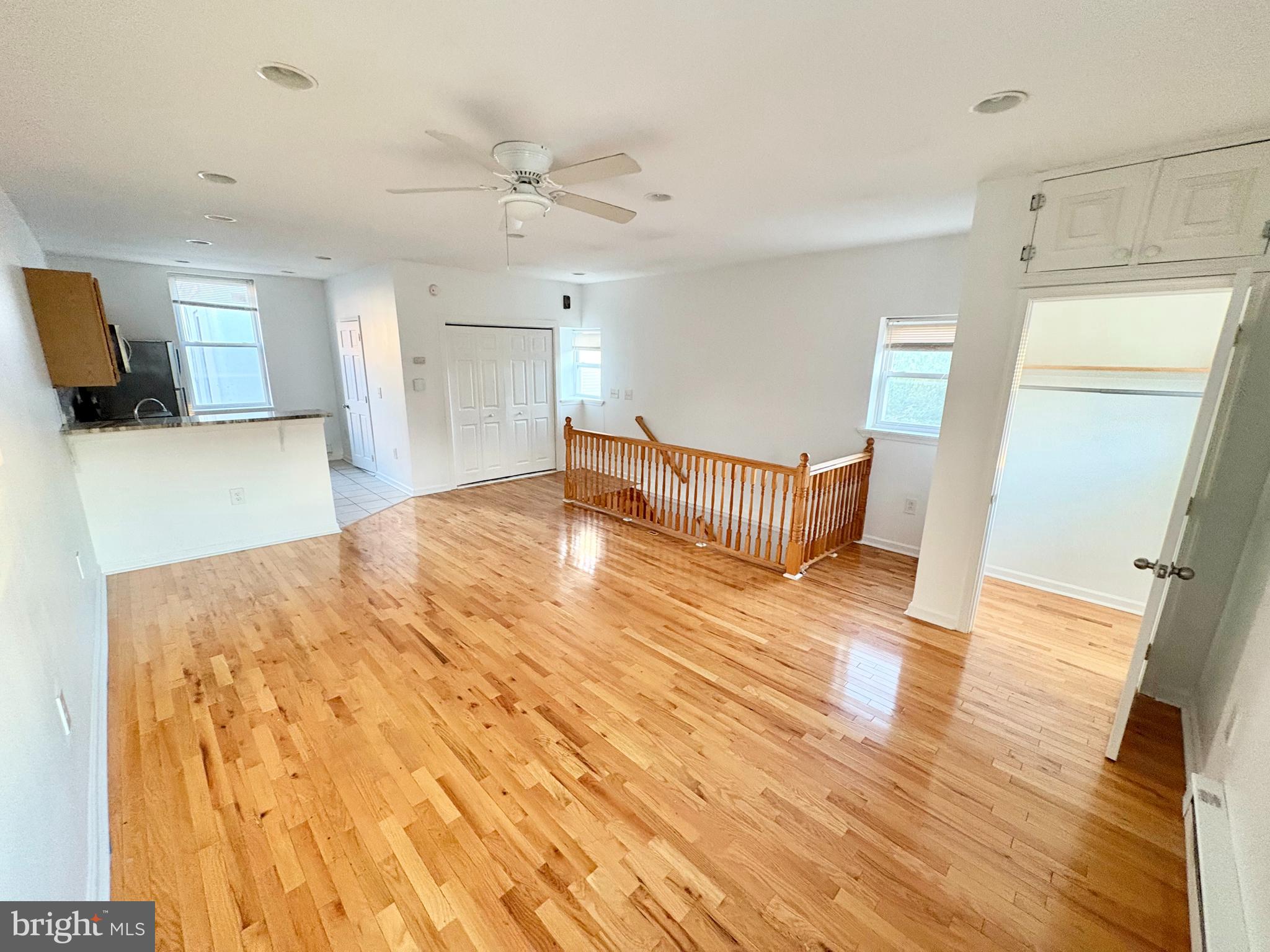 a spacious bedroom with a bed and wooden floor