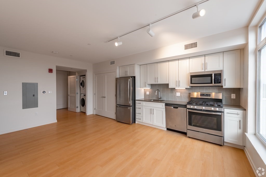 a kitchen with stainless steel appliances granite countertop a stove and a refrigerator