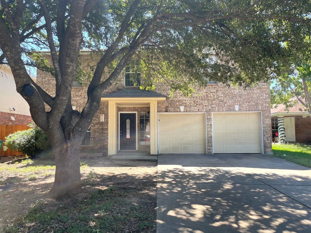 a view of a house with a tree in the background