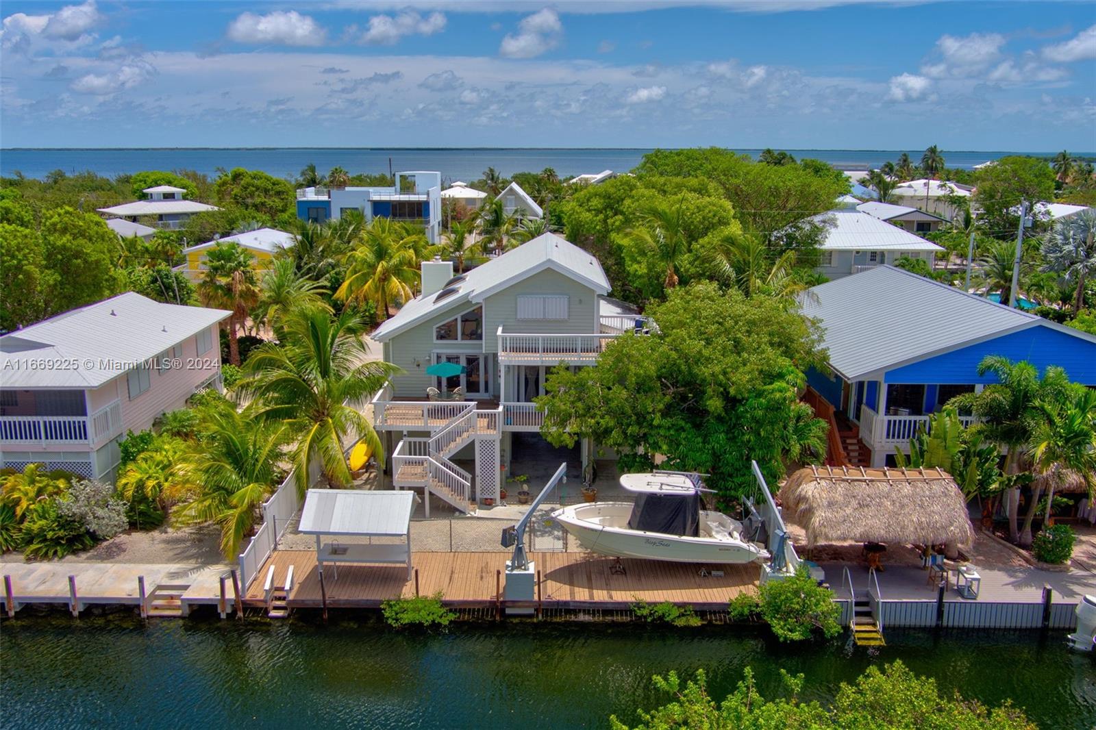 an aerial view of a house with a garden and lake view