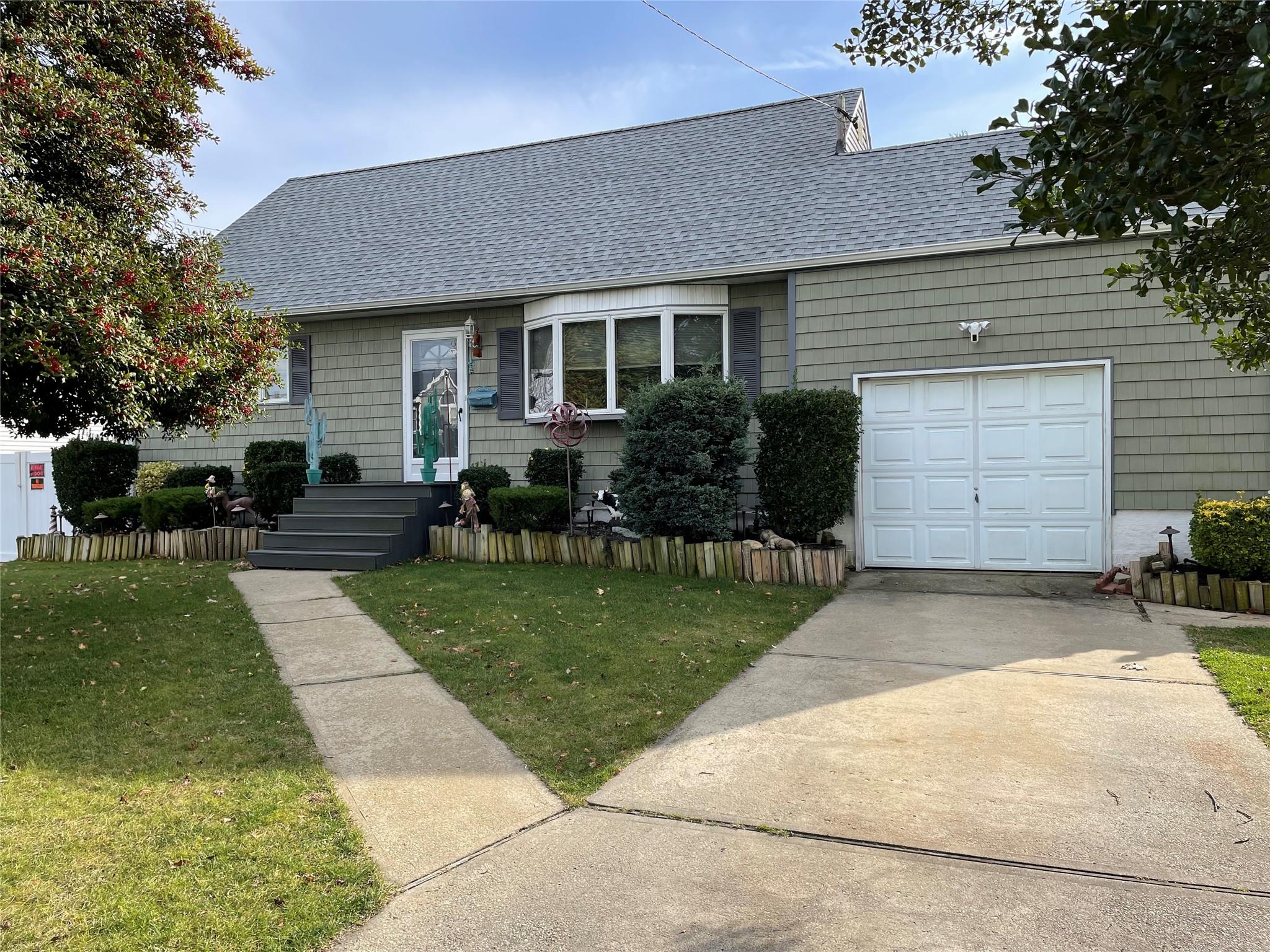 a front view of house with a garden and patio