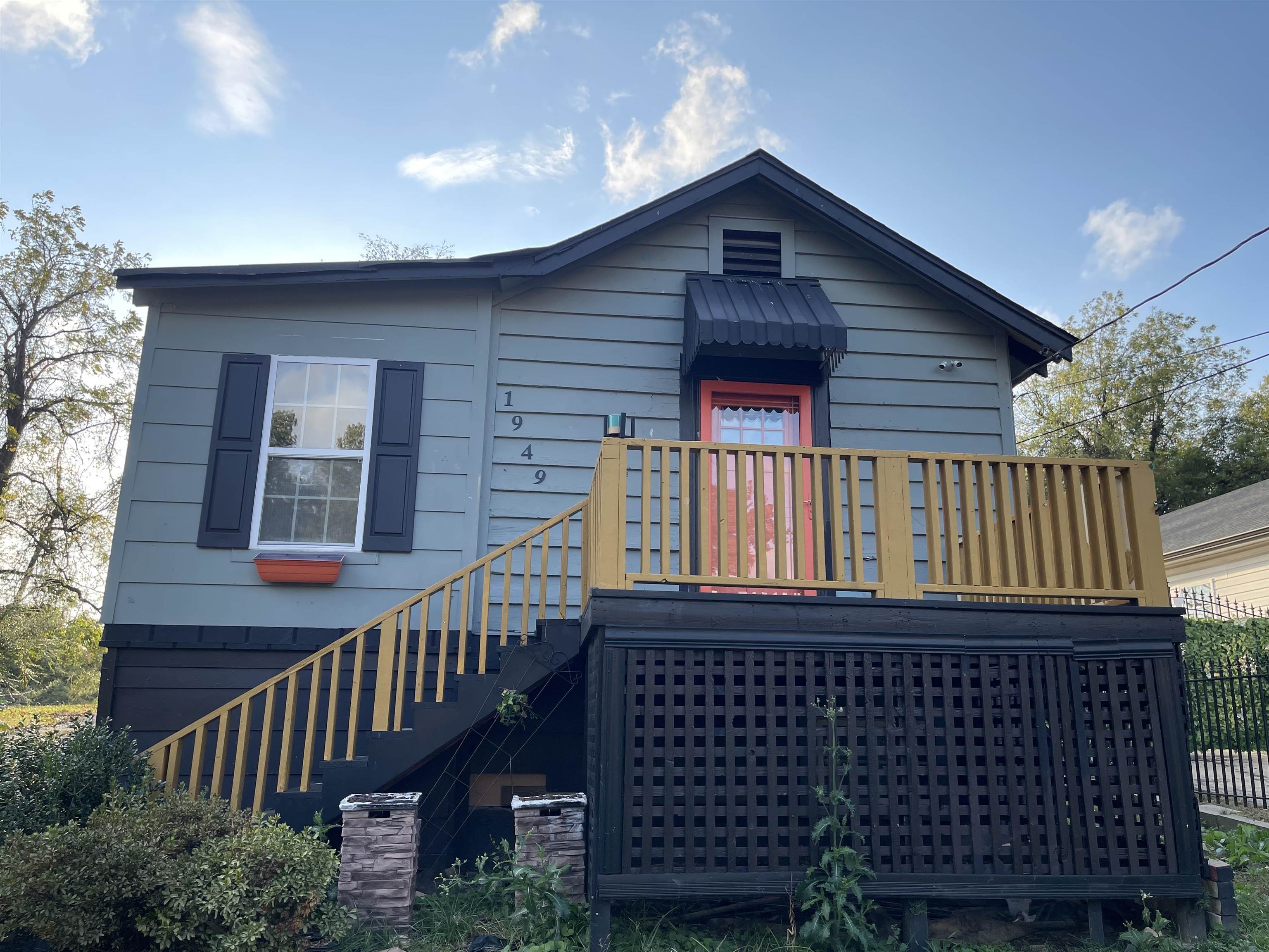 a view of a brick house with wooden fence