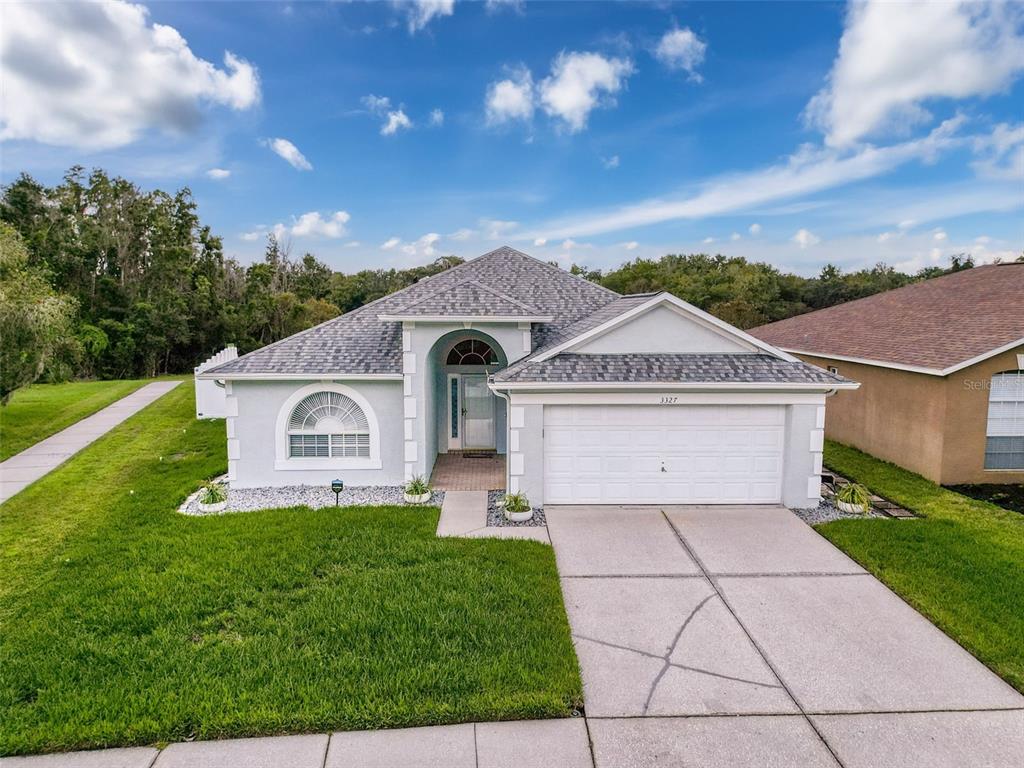 a front view of a house with a yard and garage