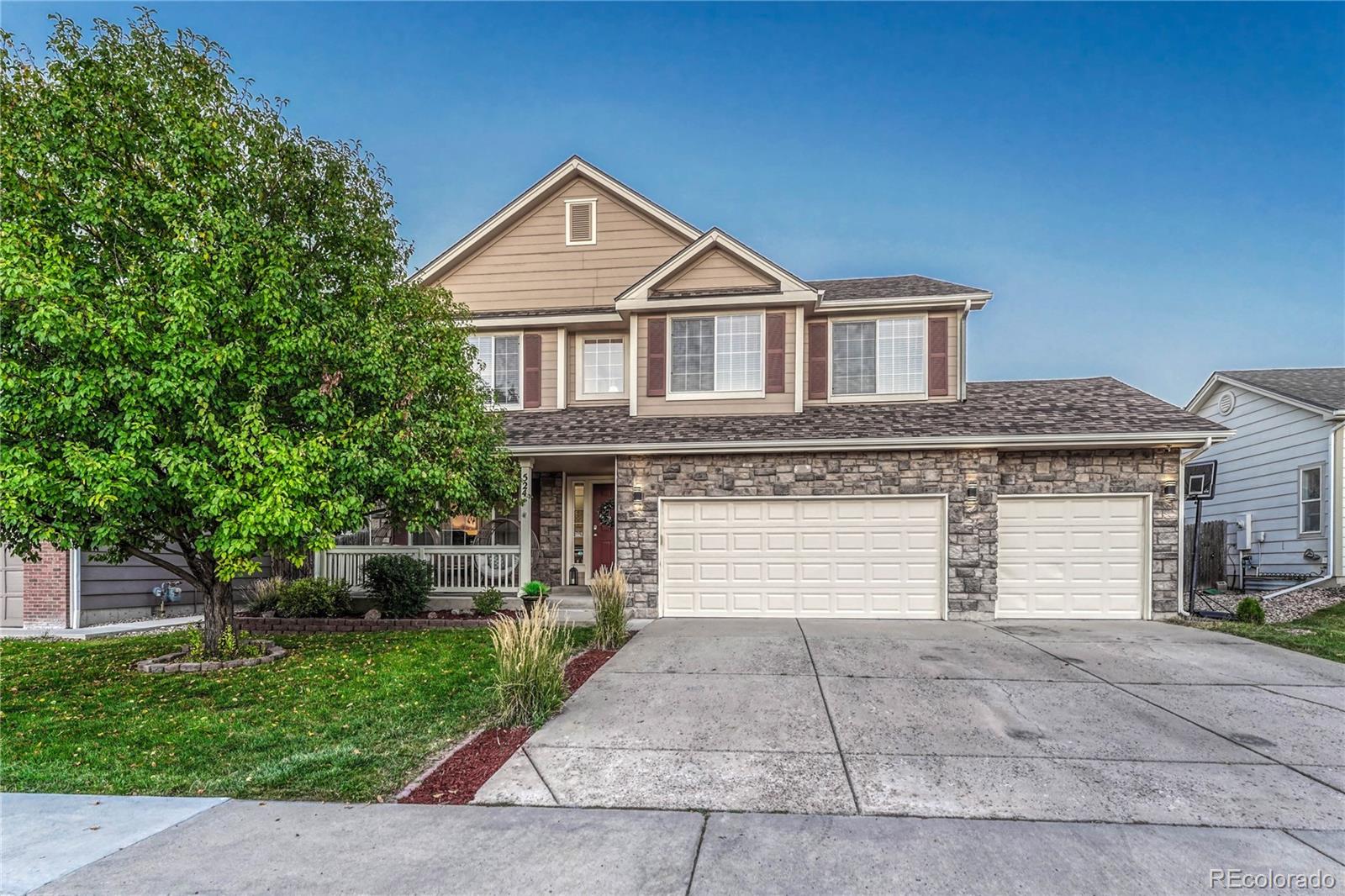 a front view of a house with a yard and garage