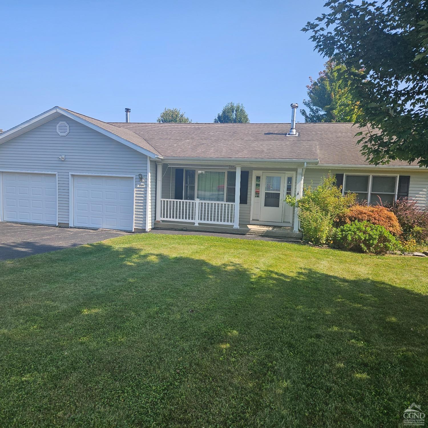 a front view of house with yard and green space