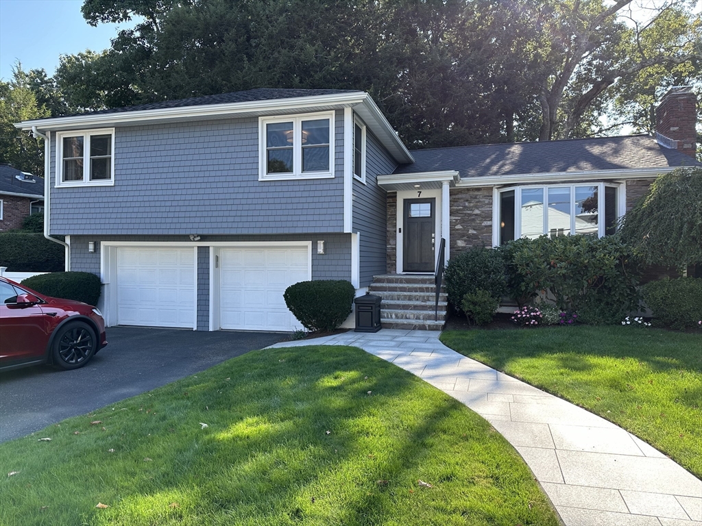 a front view of a house with a garden