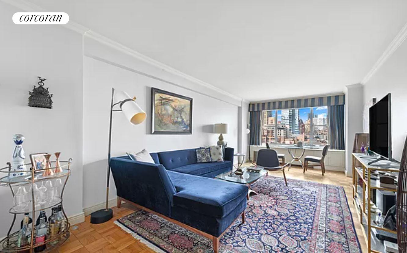 a living room with furniture a rug and a flat screen tv