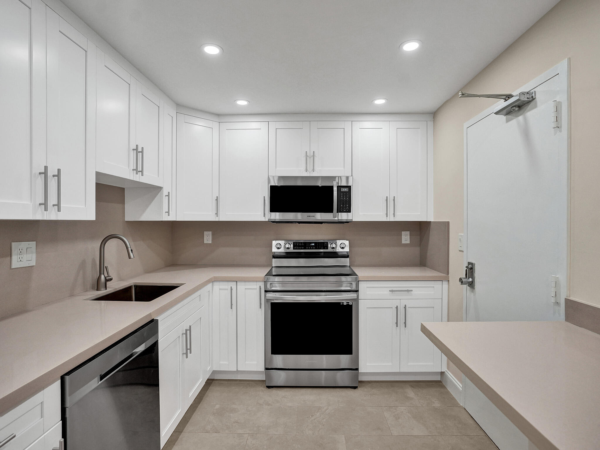 a kitchen with a sink stove and white cabinets