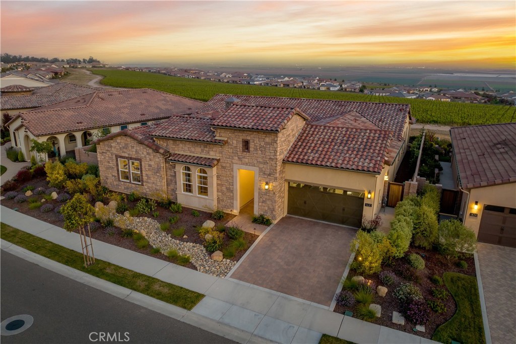 an aerial view of a house with a yard